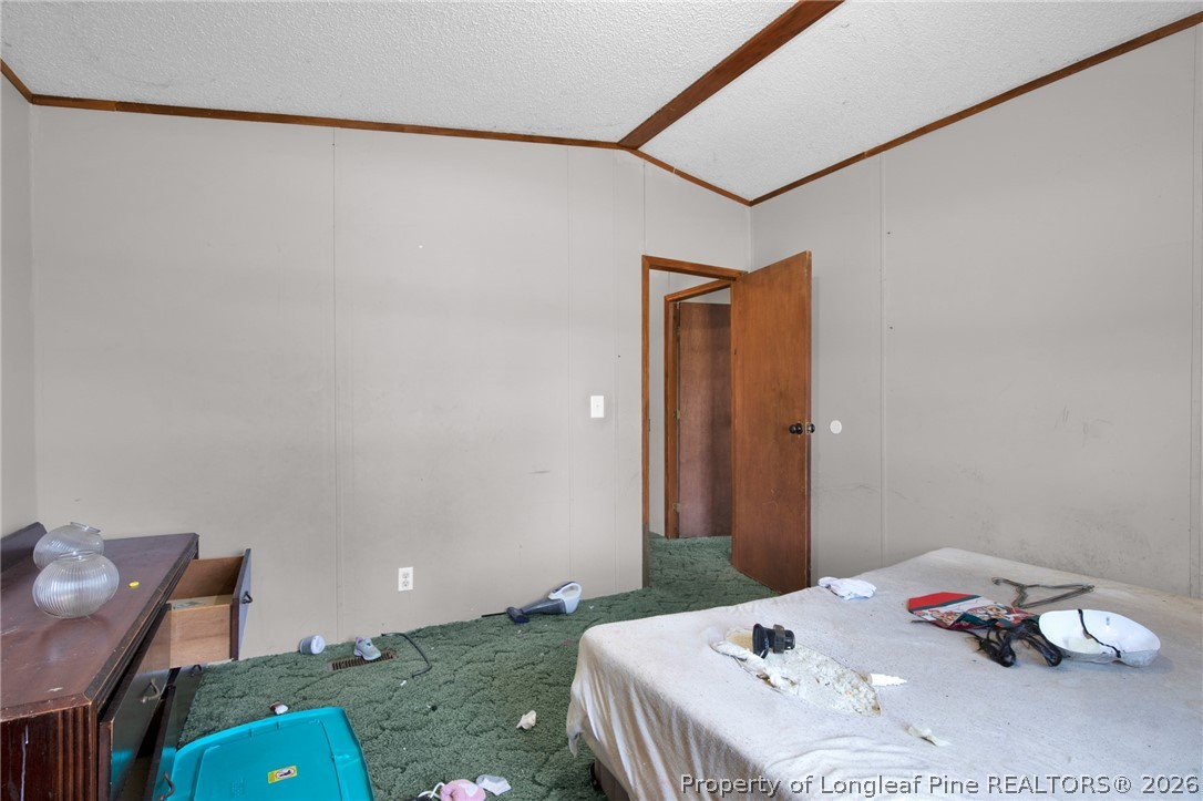 4705 Hickory Ridge Road Parkton, NC 28371 - Photo 27 of 37 a bedroom with a bed and a table in it