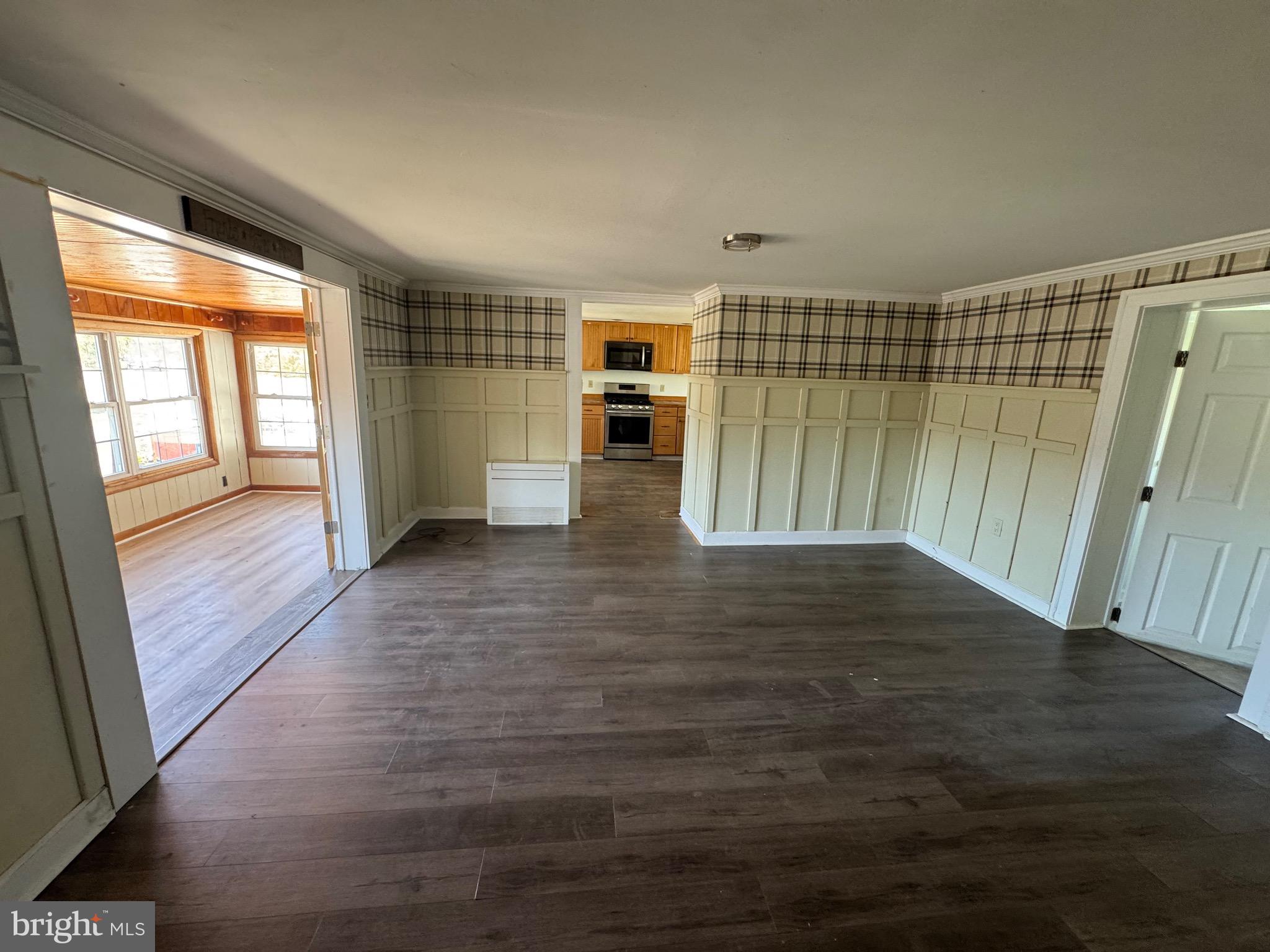5511 Cassons Neck Road Cambridge, MD 21613 - Photo 17 of 24 an empty room with wooden floor and windows