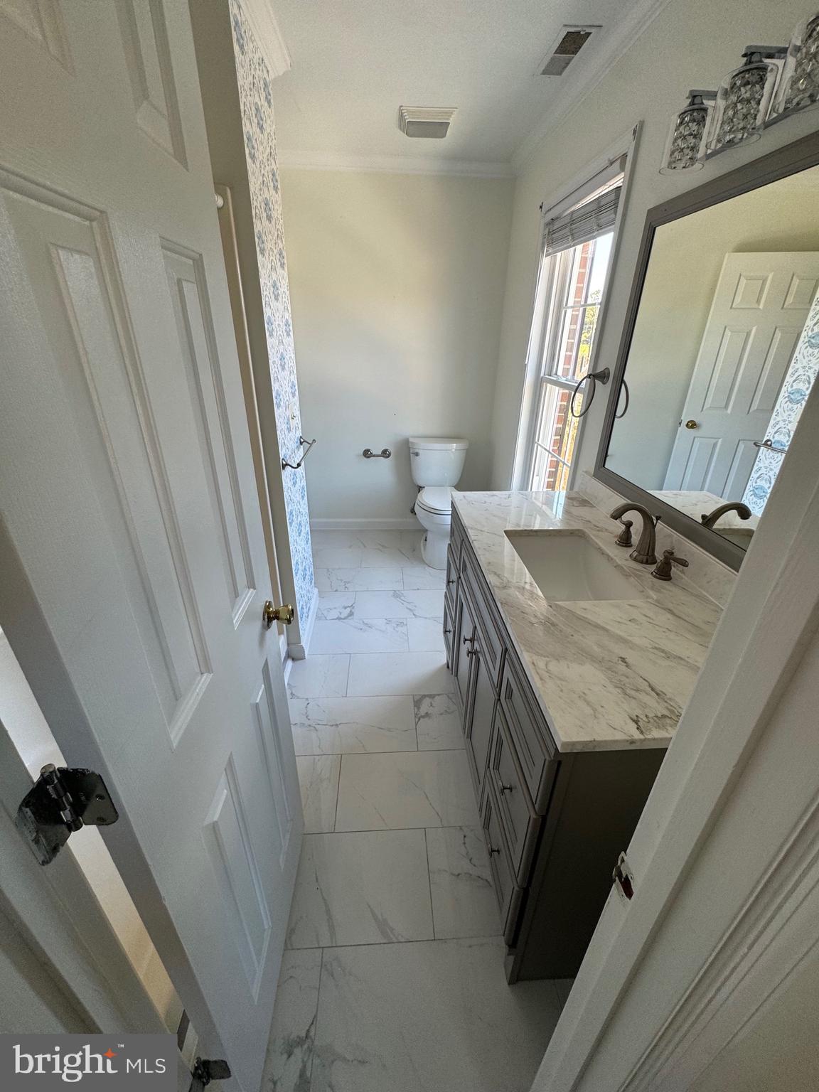 5511 Cassons Neck Road Cambridge, MD 21613 - Photo 7 of 20 a bathroom with a granite countertop sink toilet and shower