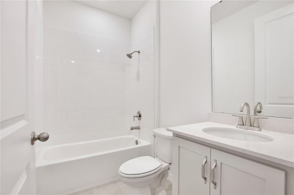 5724 Haystack Drive St. Cloud, FL 34771 - Photo 15 of 23 a bathroom with a granite countertop sink a toilet and shower