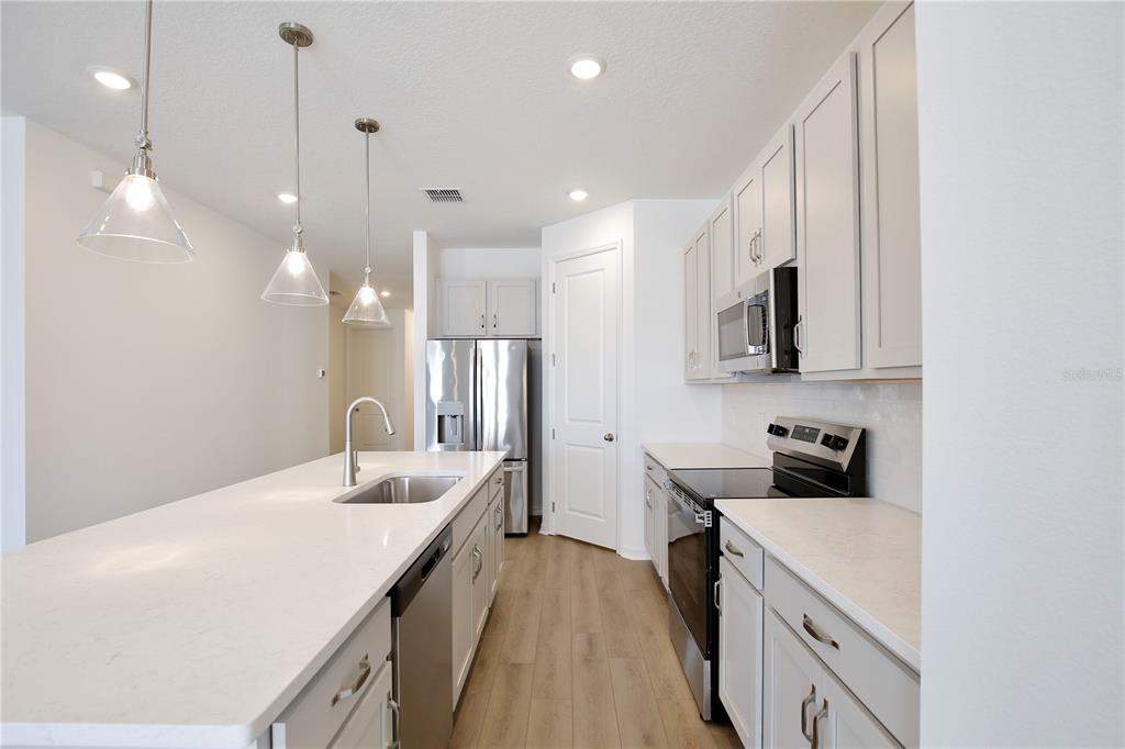 5724 Haystack Drive St. Cloud, FL 34771 - Photo 3 of 23 a kitchen with a sink a counter space appliances and cabinets
