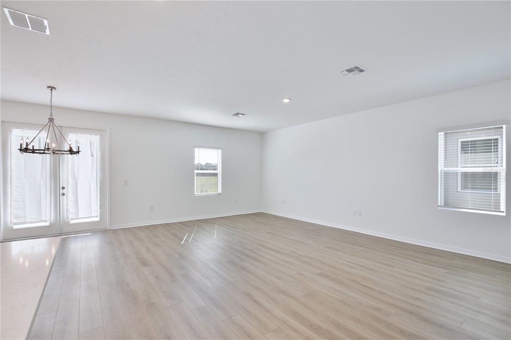 5724 Haystack Drive St. Cloud, FL 34771 - Photo 5 of 23 a view of an empty room with wooden floor and a window