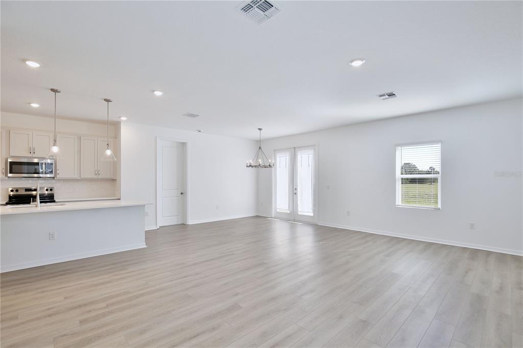 5724 Haystack Drive St. Cloud, FL 34771 - Photo 6 of 23 a view of kitchen with wooden floor and electronic appliances
