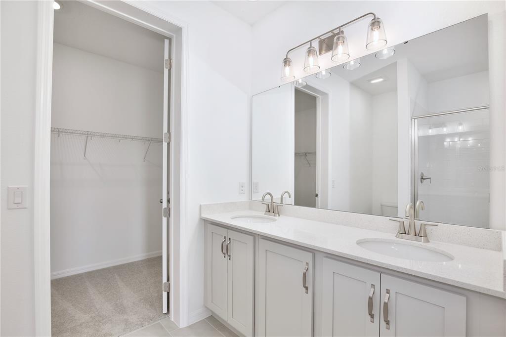 5724 Haystack Drive St. Cloud, FL 34771 - Photo 10 of 23 a bathroom with a double vanity sink and a mirror