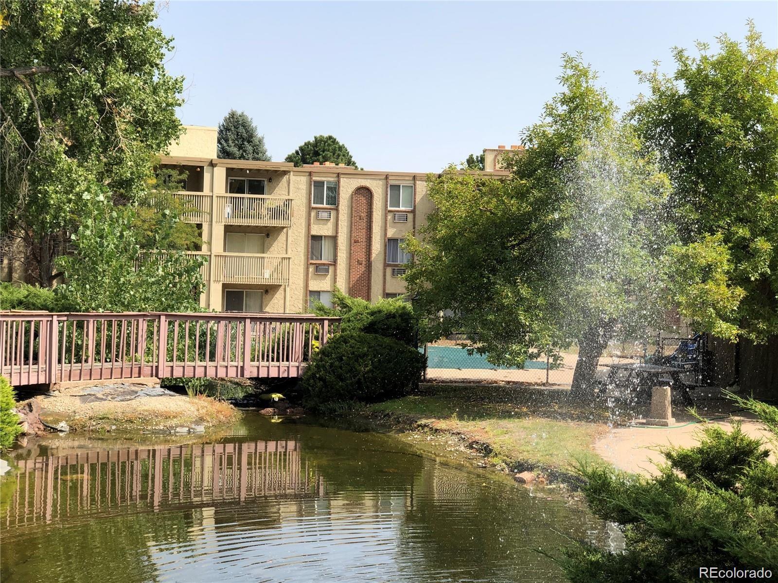 1304 South Parker Road, Unit 240 Denver, CO 80231 - Photo 8 of 19 a balcony with plants and lake view
