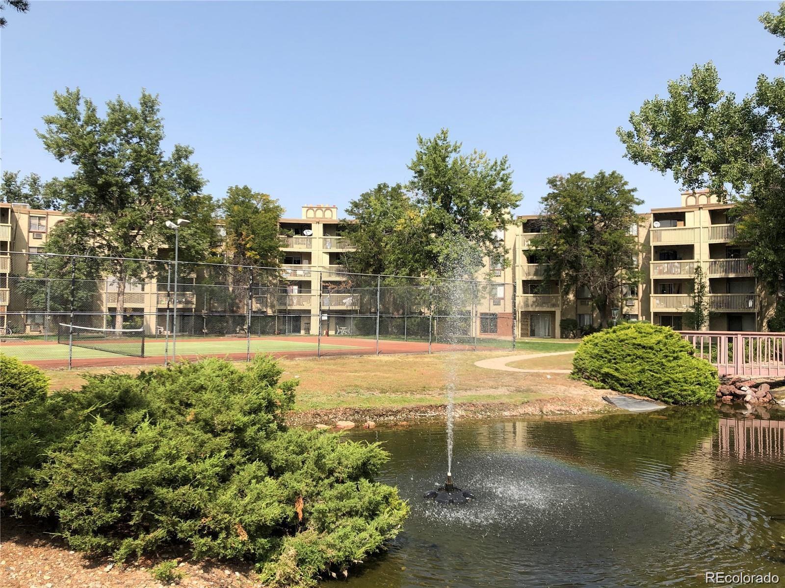 1304 South Parker Road, Unit 240 Denver, CO 80231 - Photo 9 of 19 a swimming pool with trees in the background