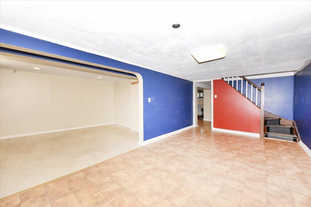 85-76 66th Road Queens, NY 11374 - Photo 12 of 20 Finished below grade area with tile patterned floors, stairway, and recessed lighting