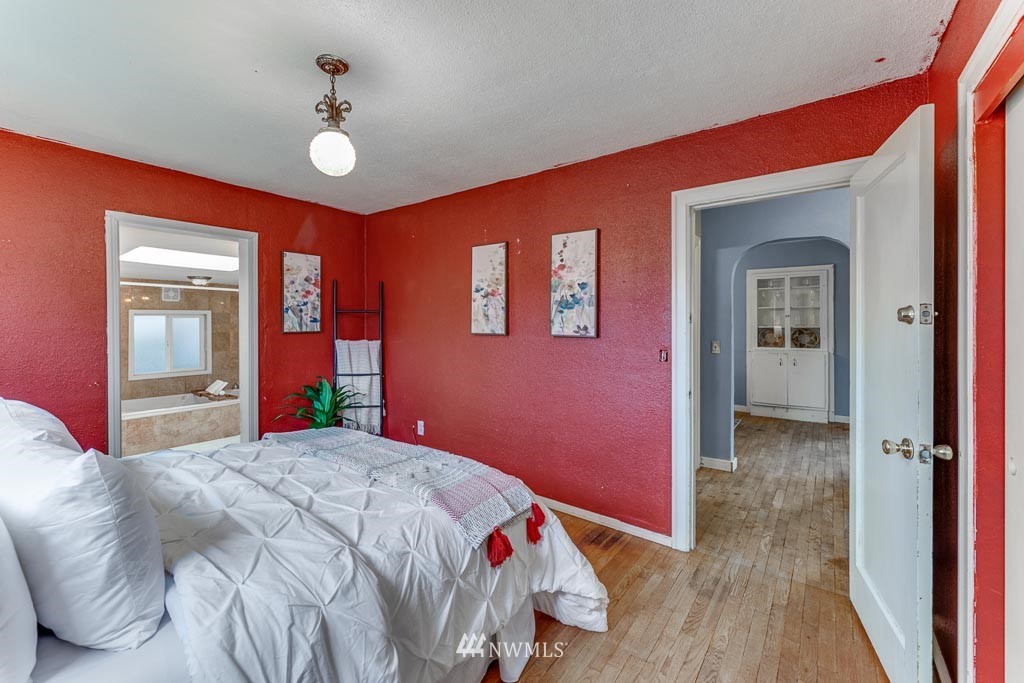 301 North Cabot Road Everett, WA 98203 - Photo 15 of 36 a bedroom with a bed and a chandelier