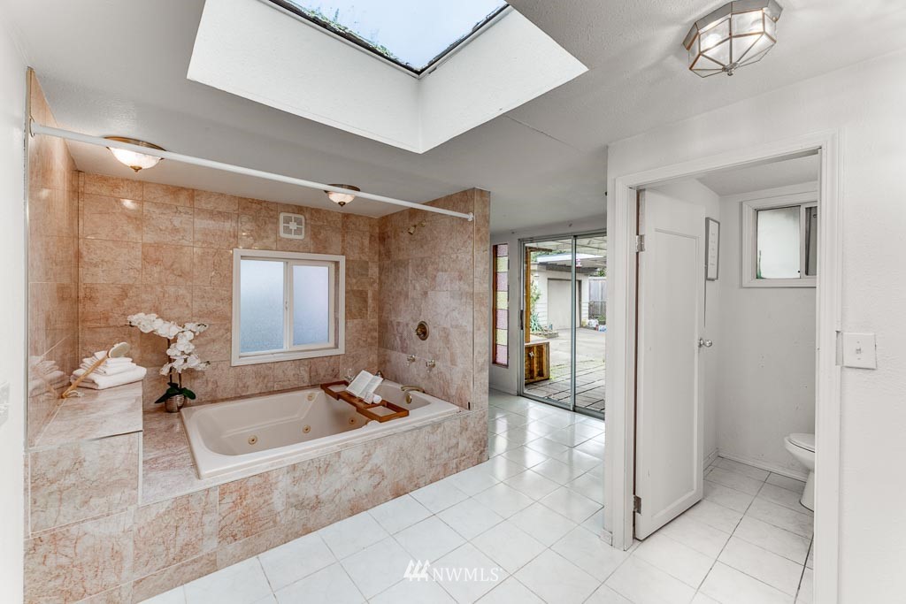 301 North Cabot Road Everett, WA 98203 - Photo 17 of 36 a spacious bathroom with a tub shower and mirror