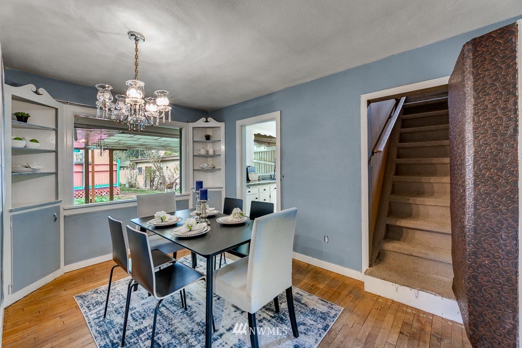 301 North Cabot Road Everett, WA 98203 - Photo 22 of 36 a dining room with furniture a chandelier and wooden floor