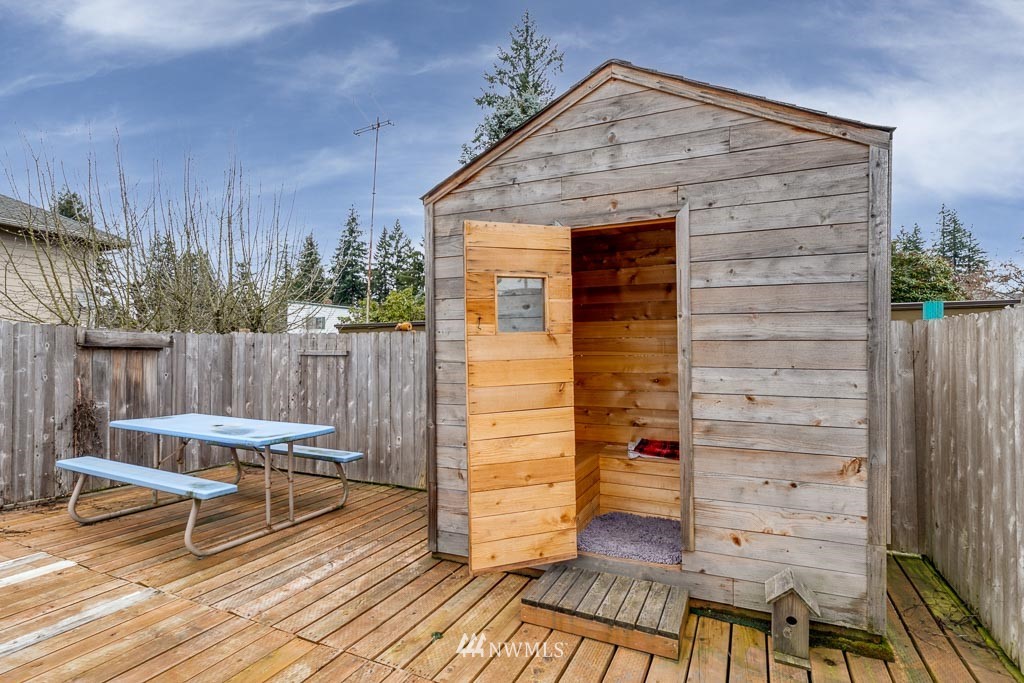 301 North Cabot Road Everett, WA 98203 - Photo 30 of 36 a view of a deck with table and chairs with wooden floor and fence