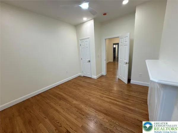 a view of hallway with wooden floor