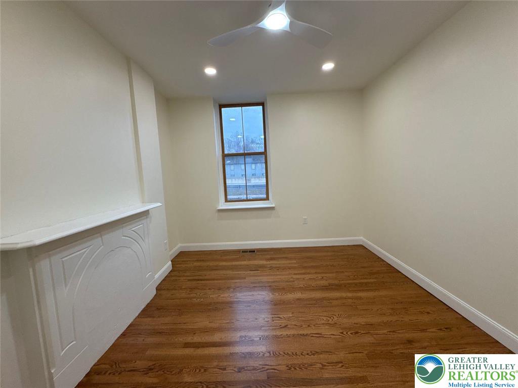 136 Bushkill Street, Unit 1 Easton, PA 18042 - Photo 6 of 11 a view of an empty room with wooden floor and a window