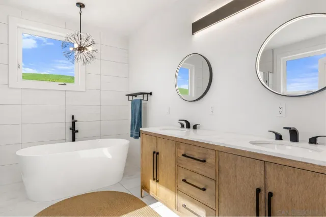 a bathroom with a white bath tub and a shower