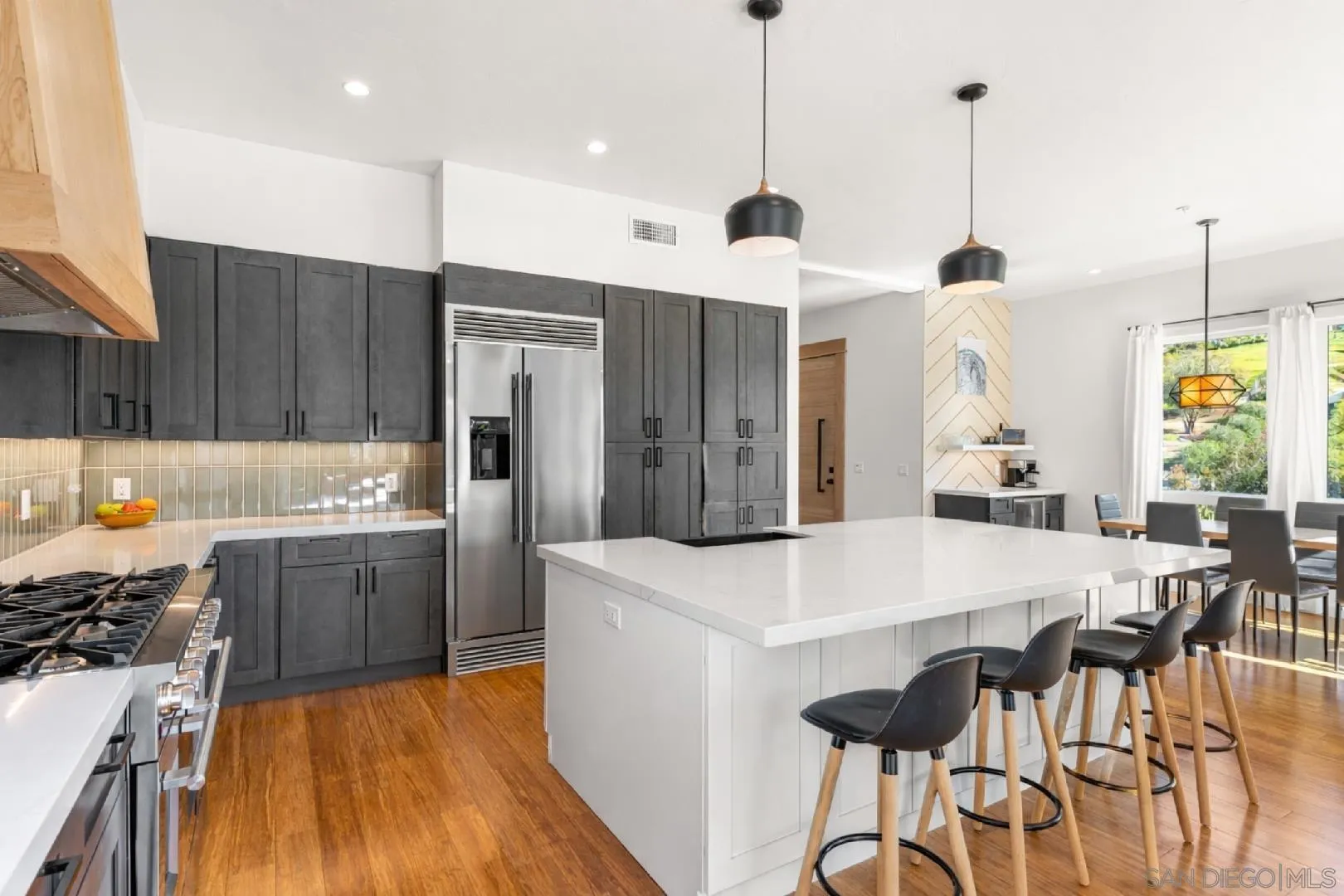 4407 Ramona Drive Fallbrook, CA 92028 - Photo 6 of 27 a large kitchen with granite countertop a stove a sink a refrigerator and a wooden floor