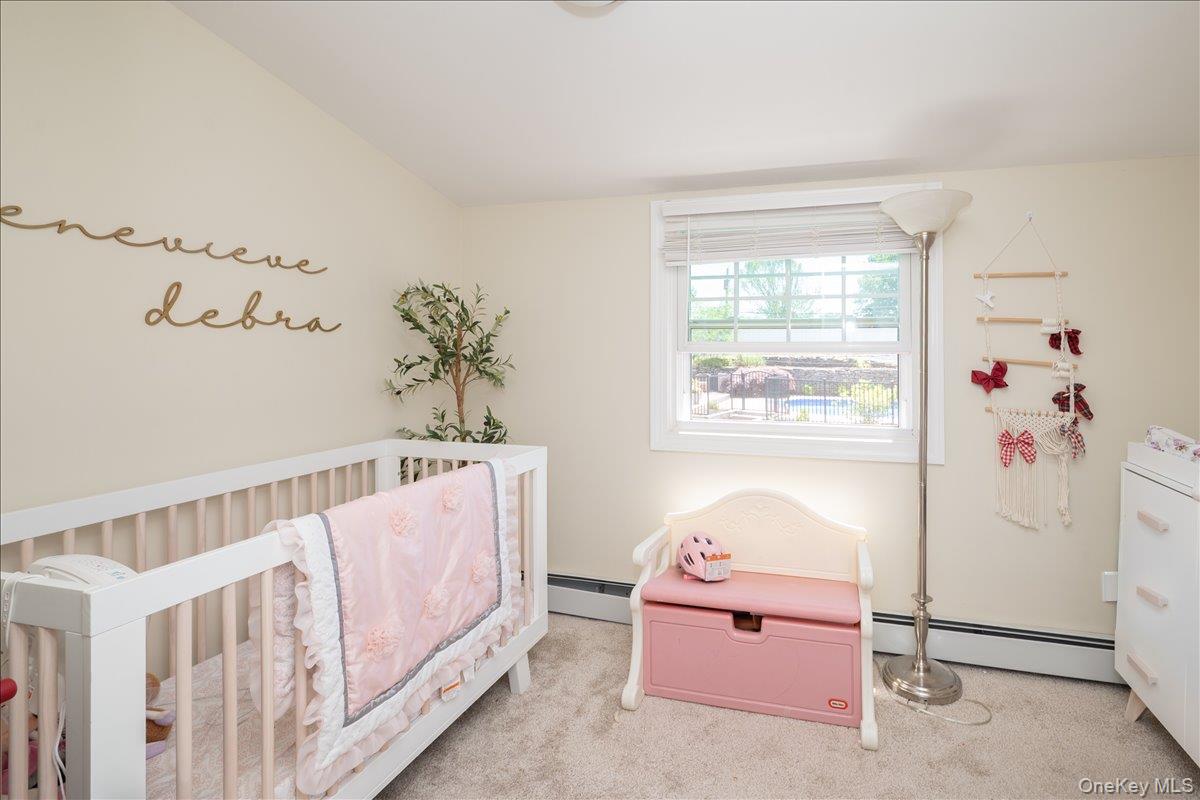 10 Rutgers Road Farmingville, NY 11738 - Photo 17 of 27 a bedroom with furniture a baby crib and a window