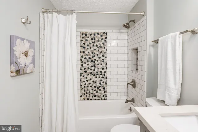 a bathroom with a bathtub and shower