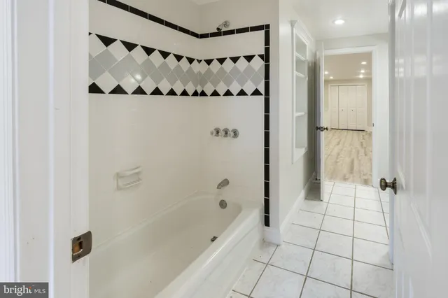 a bathroom with a bathtub and shower