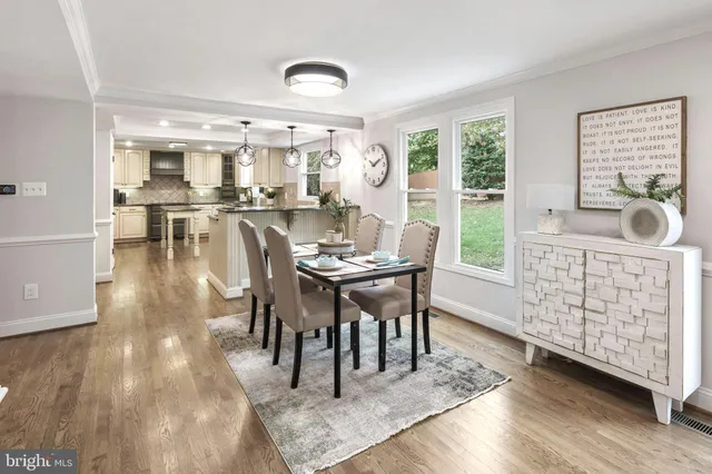 a dining room with furniture window and wooden floor