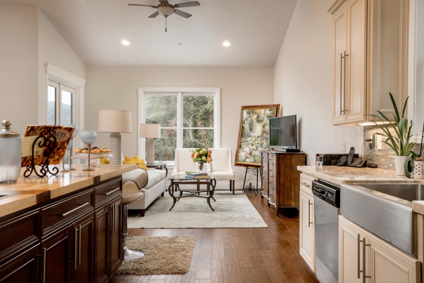 9945 Eddy Road Carmel, CA 93923 - Photo 12 of 31 a living room with furniture a rug kitchen view and large windows
