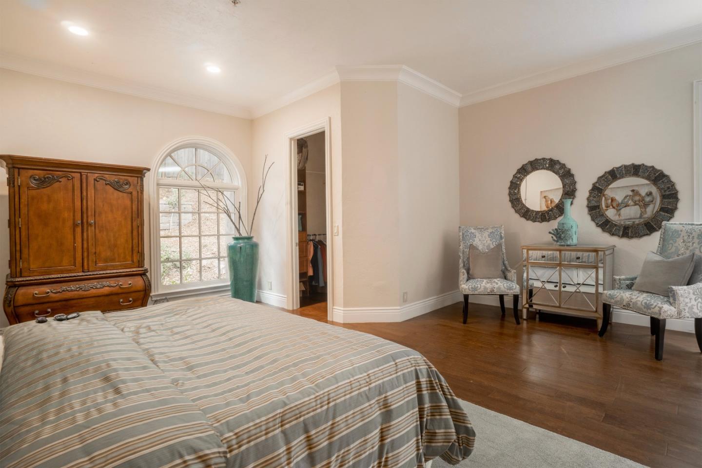 9945 Eddy Road Carmel, CA 93923 - Photo 17 of 31 a bedroom with a bed a dresser next to a window