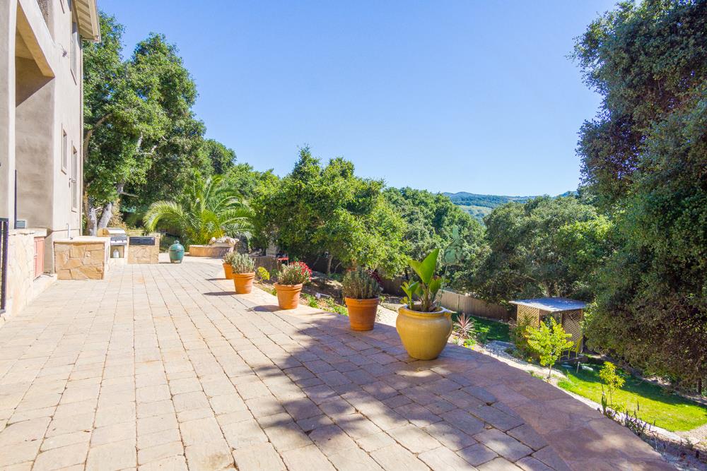 9945 Eddy Road Carmel, CA 93923 - Photo 26 of 31 a view of a patio with table and chairs potted plants with wooden fence