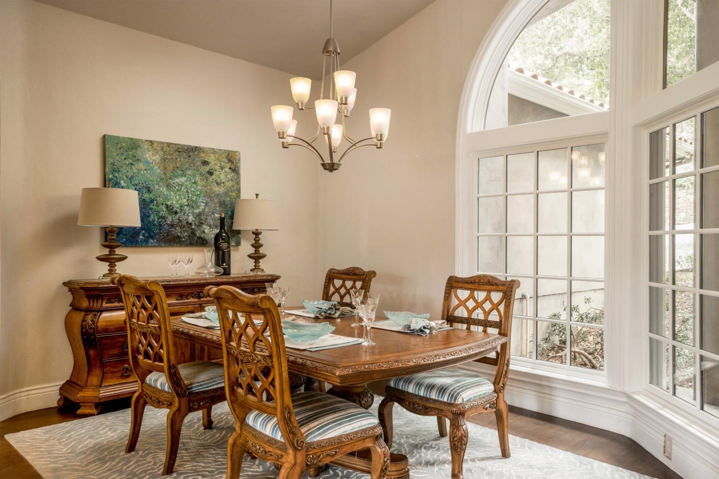 9945 Eddy Road Carmel, CA 93923 - Photo 6 of 31 a view of a dining room with furniture a chandelier and wooden floor