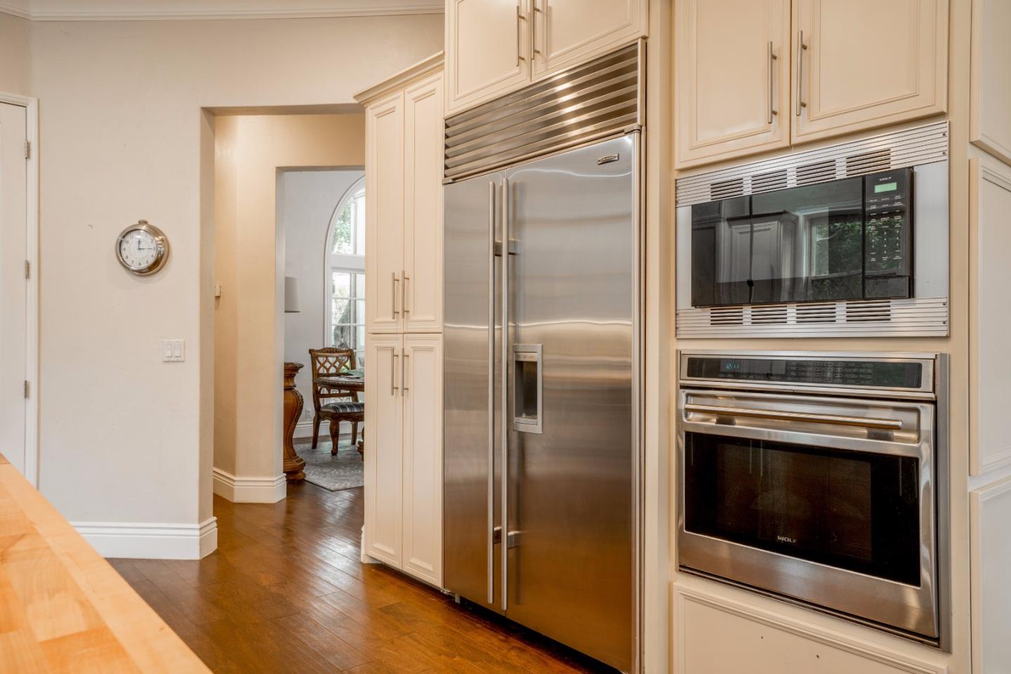 9945 Eddy Road Carmel, CA 93923 - Photo 10 of 31 a kitchen with a refrigerator and cabinets