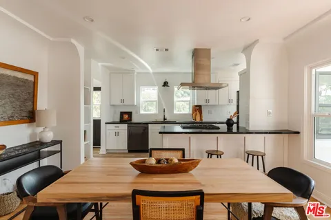 a kitchen with a table chairs and a stove