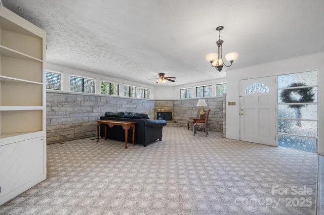 a living room with furniture a window and kitchen view