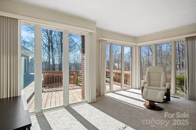 a living room with furniture and a floor to ceiling window