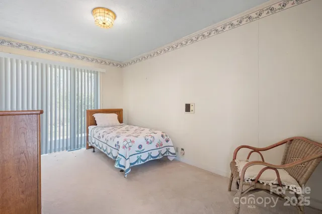 a bedroom with a bed and chair