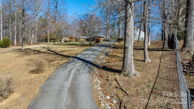 a view of a house with a wooden fence