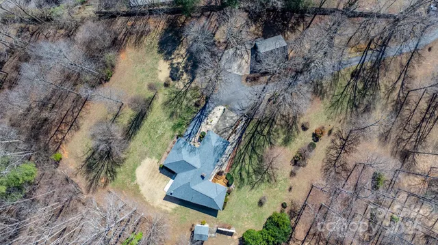 a view of trees and covered with snow in front of house