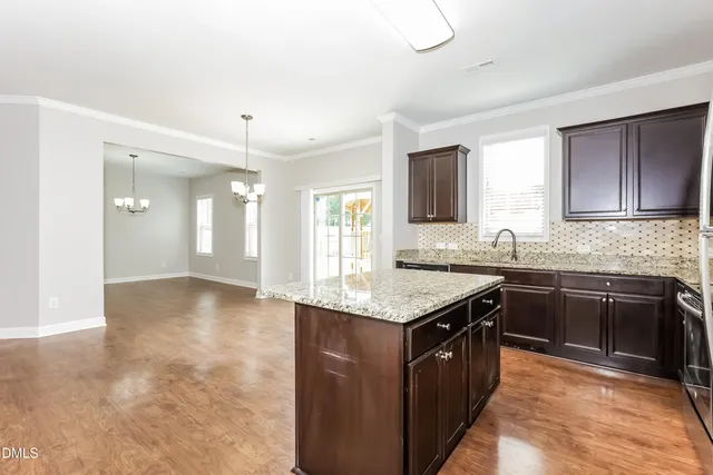 a kitchen with stainless steel appliances granite countertop a sink stove and cabinets