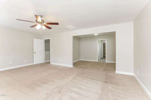 a view of a room with a ceiling fan and a window