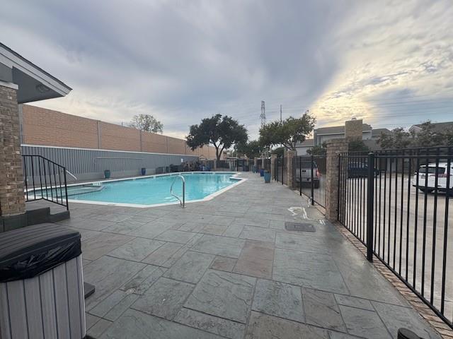 17490 Meandering Way, Unit 505 Dallas, TX 75252 - Photo 15 of 16 Community pool with a fenced backyard and a patio area