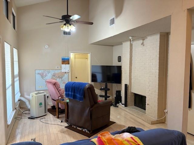 17490 Meandering Way, Unit 505 Dallas, TX 75252 - Photo 2 of 16 Living room featuring high vaulted ceiling, light wood finished floors, a fireplace, and a ceiling fan