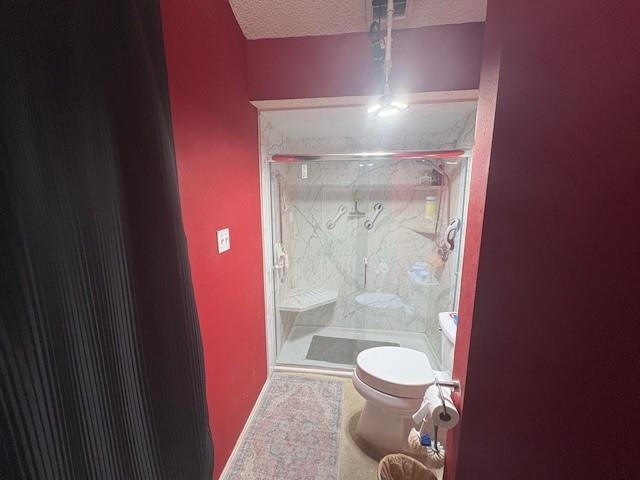 17490 Meandering Way, Unit 505 Dallas, TX 75252 - Photo 9 of 16 Full bath with a marble finish shower and a textured ceiling