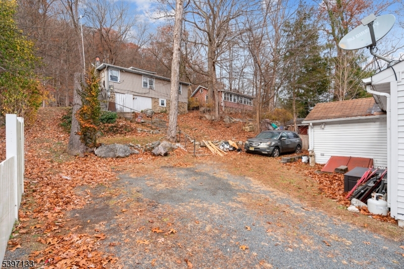 4 Bank Street Stanhope, NJ 07874 - Photo 3 of 6 a backyard of a house with cars parked on road