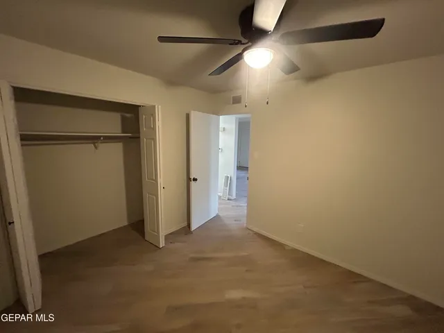 an empty room with closet area