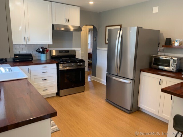 345 Courtland Avenue Bridgeport, CT 06605 - Photo 11 of 38 a kitchen with stainless steel appliances a refrigerator stove and microwave