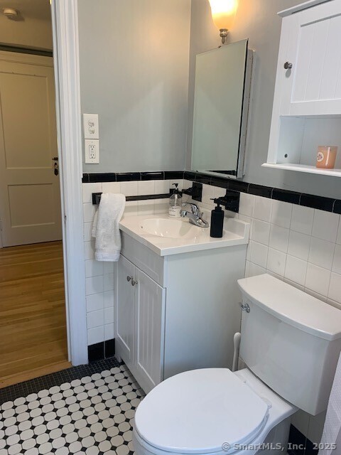345 Courtland Avenue Bridgeport, CT 06605 - Photo 15 of 38 a bathroom with a sink a toilet a mirror and shower