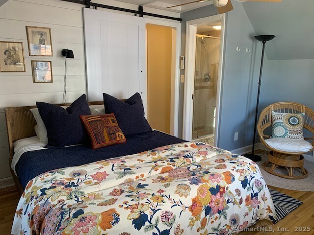 345 Courtland Avenue Bridgeport, CT 06605 - Photo 16 of 38 a bedroom with a bed and wooden floor