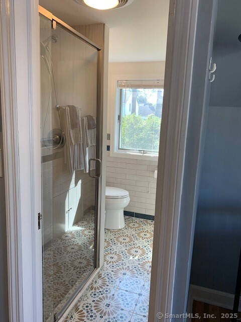 345 Courtland Avenue Bridgeport, CT 06605 - Photo 19 of 38 a bathroom with a granite countertop shower a toilet and a sink