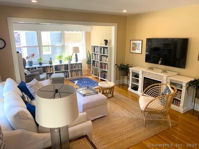 345 Courtland Avenue Bridgeport, CT 06605 - Photo 2 of 38 a living room with furniture a flat screen tv and a floor to ceiling window