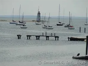 a patio with wooden floor table and chairs