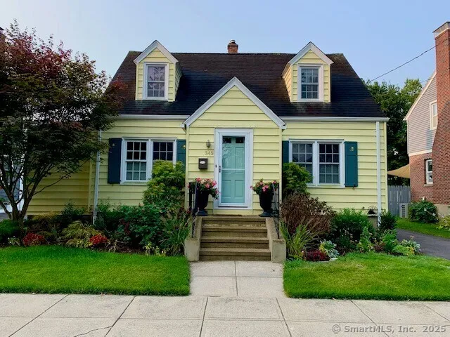 a front view of house with yard and outdoor seating
