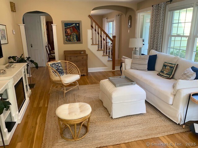 345 Courtland Avenue Bridgeport, CT 06605 - Photo 3 of 38 a living room with furniture and a large mirror