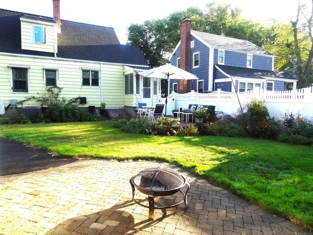 a wooden bench sitting in the middle of a yard